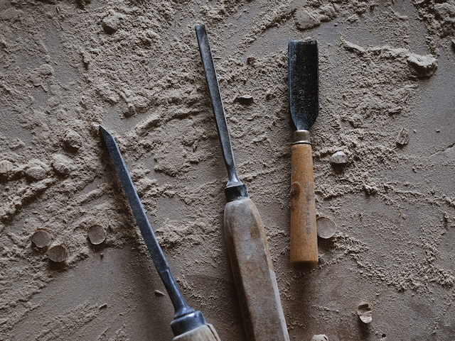 Three woodworking tools are shown on sawdust